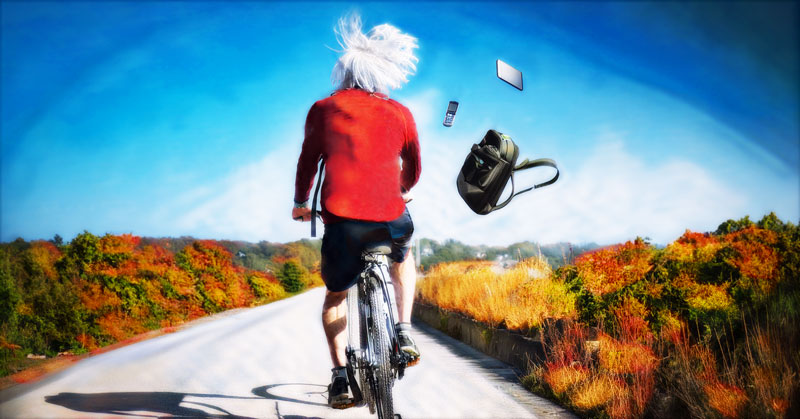 Man riding a bike, backpack and cell phone flying