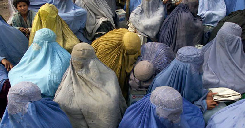 Afghan women in burqas, refugee camp in Pakistan